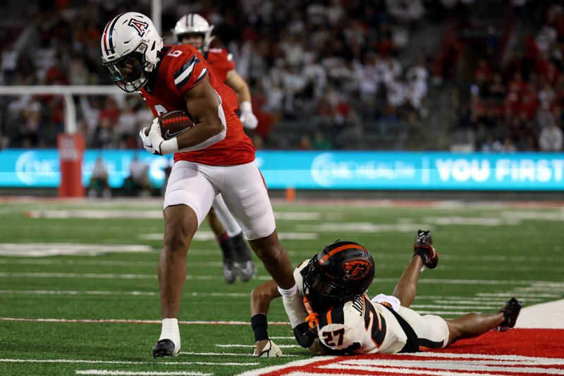 Oct 28, 2023; Tucson, Arizona, USA; Arizona Wildcats running back Michael Wiley #6 runs the ball for a touchdown against Oregon State Beavers defensive back Andre Jordan Jr. #27 during the second half at Arizona Stadium. Mandatory Credit: Zachary BonDurant-USA TODAY Sports