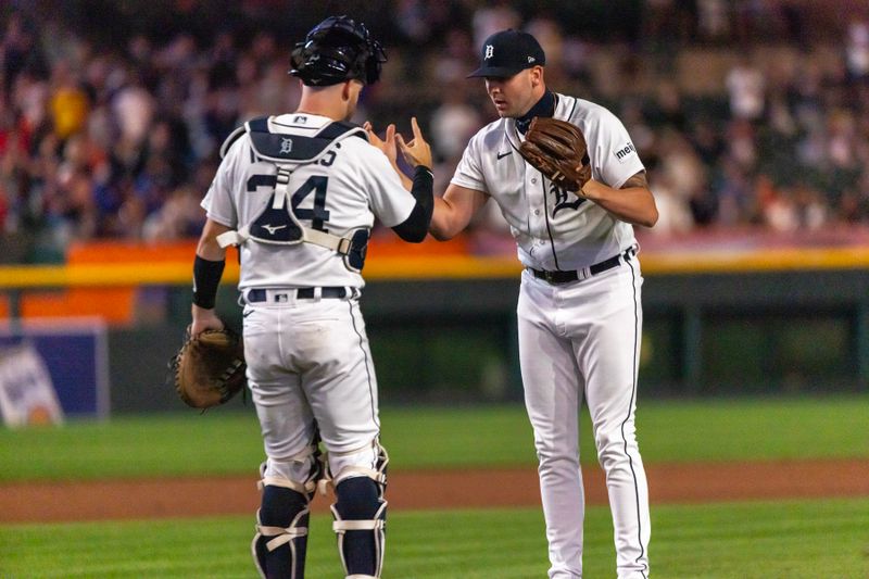 Aug 22, 2023; Detroit, Michigan, USA; Detroit Tigers relief pitcher Alex Lange (55) shakes hands with teammate catcher Jake Rogers (34) after the win against the Chicago Cubs at Comerica Park. Mandatory Credit: David Reginek-USA TODAY Sports