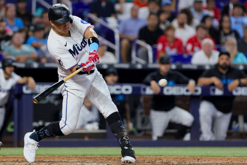 Jul 30, 2023; Miami, Florida, USA; Miami Marlins right fielder Avisail Garcia (24) hits an RBI single against the Detroit Tigers during the sixth inning at loanDepot Park. Mandatory Credit: Sam Navarro-USA TODAY Sports