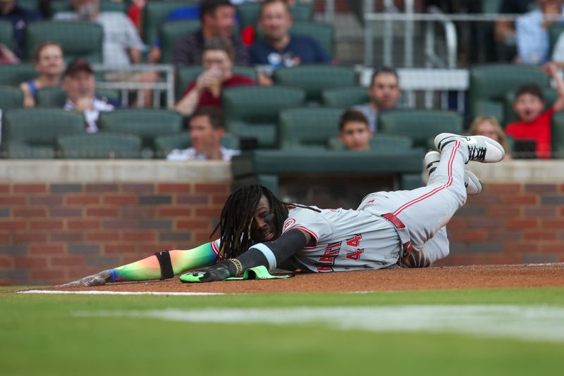 Jul 22, 2024; Atlanta, Georgia, USA; Cincinnati Reds shortstop Elly De La Cruz (44) reacts after scoring a run against the Atlanta Braves in the first inning at Truist Park. Mandatory Credit: Brett Davis-USA TODAY Sports