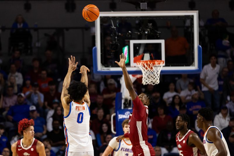 Jan 13, 2024; Gainesville, Florida, USA; Florida Gators guard Zyon Pullin (0) shoots the ball over Arkansas Razorbacks guard Layden Blocker (6) during the first half at Exactech Arena at the Stephen C. O'Connell Center. Mandatory Credit: Matt Pendleton-USA TODAY Sports