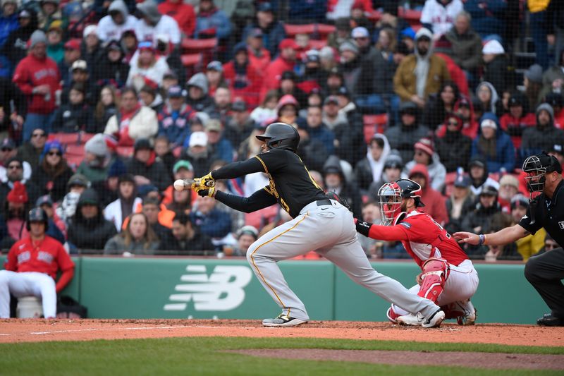 Apr 5, 2023; Boston, Massachusetts, USA; Pittsburgh Pirates third baseman Ke'Bryan Hayes (13) bunts to bring home a runner during the sixth inning against the Boston Red Sox at Fenway Park. Mandatory Credit: Eric Canha-USA TODAY Sports