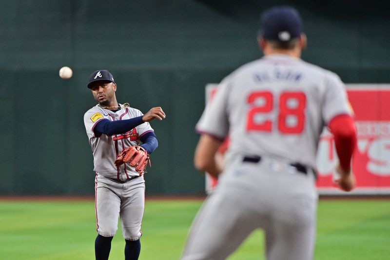 Jul 10, 2024; Phoenix, Arizona, USA;  Atlanta Braves second baseman Ozzie Albies (1) throws to first baseman Matt Olson (28) in the third inning against the Arizona Diamondbacks at Chase Field. Mandatory Credit: Matt Kartozian-USA TODAY Sports