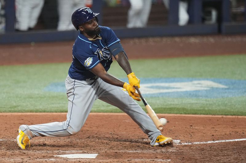 Aug 30, 2023; Miami, Florida, USA; Tampa Bay Rays left fielder Randy Arozarena (56) singles to left field to score two runs in the tenth inning against the Miami Marlins at loanDepot Park. Mandatory Credit: Jim Rassol-USA TODAY Sports