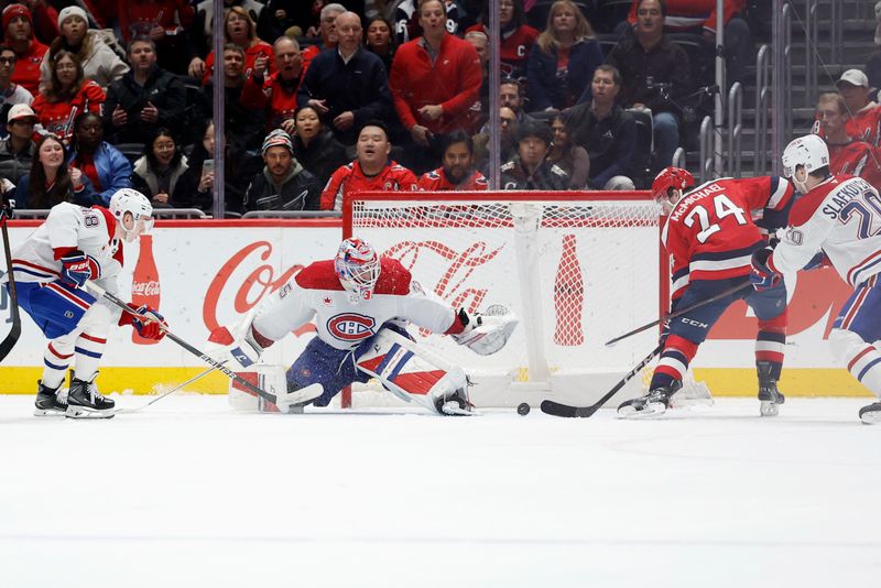 Jan 13, 2026; Washington, District of Columbia, USA; Washington Capitals center Connor McMichael (24) scores the game winning goal in overtime on Montréal Canadiens goaltender Samuel Montembeault (35) as Canadiens left wing Juraj Slafkovsk? (20) defends at Capital One Arena. Mandatory Credit: Geoff Burke-Imagn Images