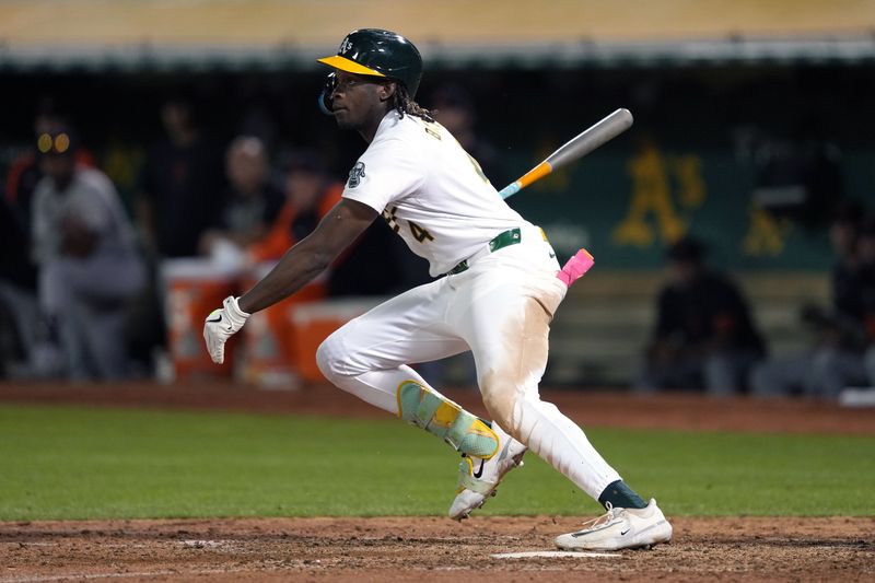 Sep 6, 2024; Oakland, California, USA; Oakland Athletics right fielder Lawrence Butler (4) hits a single against the Detroit Tigers during the seventh inning at Oakland-Alameda County Coliseum. Mandatory Credit: Darren Yamashita-Imagn Images