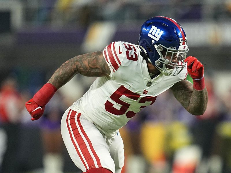 New York Giants linebacker Oshane Ximines (53) runs towards the ball during the first half of an NFL wild-card football game against the Minnesota Vikings, Sunday, Jan. 15, 2023, in Minneapolis. (AP Photo/Abbie Parr)