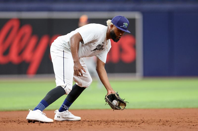 Aug 13, 2024; St. Petersburg, Florida, USA; Tampa Bay Rays third baseman Junior Caminero (13) takes fielding practice before a game against the Houston Astros at Tropicana Field. Mandatory Credit: Nathan Ray Seebeck-USA TODAY Sports