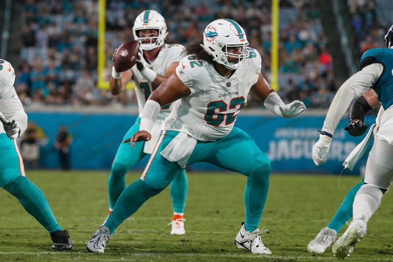 Miami Dolphins center Alama Uluave (62) in action during an NFL pre-season football game against the Jacksonville Jaguars, Saturday, Aug. 26, 2023, in Jacksonville, Fla. The Jaguars defeated the Dolphins 31-18. (AP Photo/Gary McCullough)