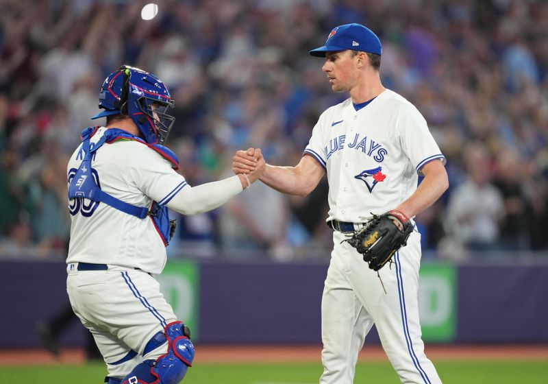 May 12, 2023; Toronto, Ontario, CAN; Toronto Blue Jays starting pitcher Chris Bassitt (40) celebrates a complete game win with Toronto Blue Jays catcher Alejandro Kirk (30) against the Atlanta Braves at the end of the  the ninth inning at Rogers Centre. Mandatory Credit: Nick Turchiaro-USA TODAY Sports