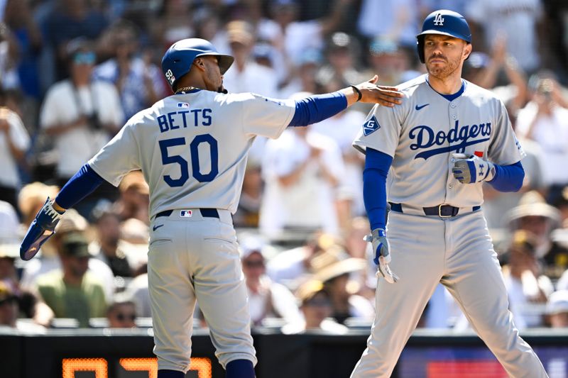 Aug 24, 2025; San Diego, California, USA; Los Angeles Dodgers first baseman Freddie Freeman (5) is congratulated by Los Angeles Dodgers shortstop Mookie Betts (50) after hitting a two-run home run during the seventh inning against the San Diego Padres at Petco Park. Mandatory Credit: Denis Poroy-Imagn Images