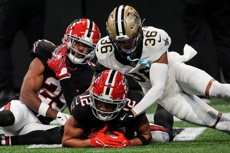 Atlanta Falcons wide receiver KhaDarel Hodge (12) recovers a fumble for a touchdown against New Orleans Saints cornerback Rico Payton (36) during the first half of an NFL football game, Sunday, Sept. 29, 2024, in Atlanta. (AP Photo/John Bazemore)