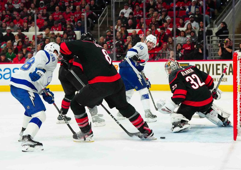 Nov 24, 2023; Raleigh, North Carolina, USA; Tampa Bay Lightning right wing Nikita Kucherov (86) send the pass behind Carolina Hurricanes goaltender Antti Raanta (32) during the second period at PNC Arena. Mandatory Credit: James Guillory-USA TODAY Sports