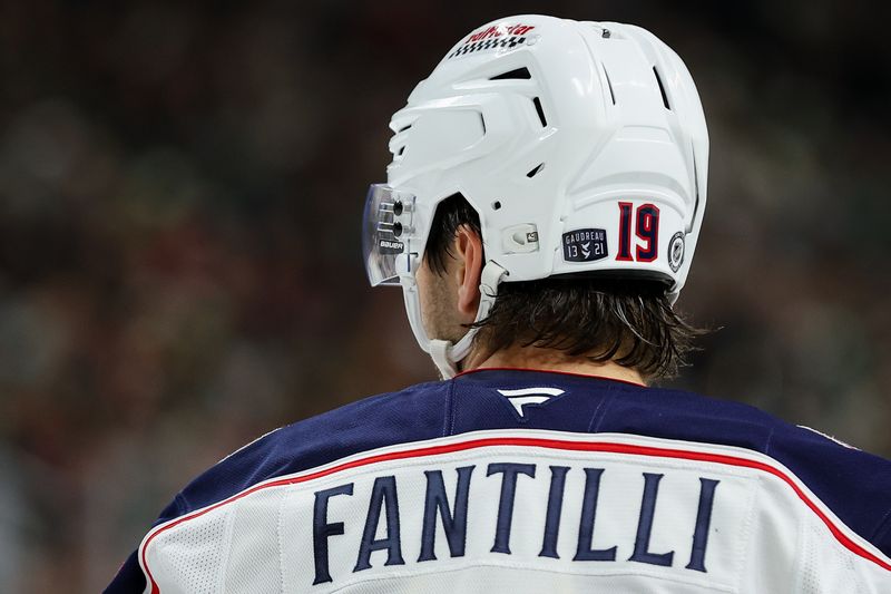 Oct 10, 2024; Saint Paul, Minnesota, USA; A sticker honoring the lives of Matthew and Johnny Gaudreau is seen on the helmet worn by Columbus Blue Jackets center Adam Fantilli (19) during the second period against the Minnesota Wild at Xcel Energy Center. Mandatory Credit: Matt Krohn-Imagn Images