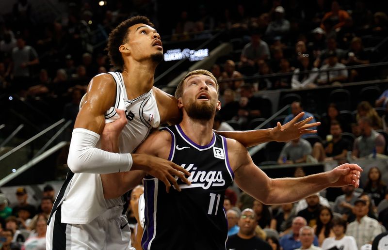 SAN ANTONIO, TX - NOVEMBER 11: Domantas Sabonis #11 of the Sacramento Kings battles for rebounding position with Victor Wembanyama #1 of the San Antonio Spurs in the first half at Frost Bank Center on November 11, 2024 in San Antonio, Texas. NOTE TO USER: User expressly acknowledges and agrees that, by downloading and or using this photograph, User is consenting to terms and conditions of the Getty Images License Agreement. (Photo by Ronald Cortes/Getty Images)