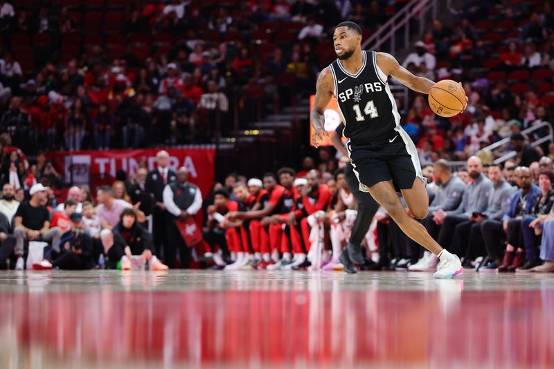 HOUSTON, TEXAS - OCTOBER 17: Blake Wesley #14 of the San Antonio Spurs dribbles down court against the Houston Rockets  during the second half of a preseason game at Toyota Center on October 17, 2024 in Houston, Texas. NOTE TO USER: User expressly acknowledges and agrees that, by downloading and or using this photograph, User is consenting to the terms and conditions of the Getty Images License Agreement. (Photo by Alex Slitz/Getty Images)