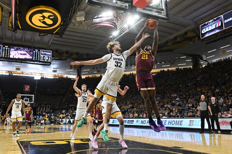 Feb 11, 2024; Iowa City, Iowa, USA; Minnesota Golden Gophers forward Pharrel Payne (21) goes to the basket as Iowa Hawkeyes forward Owen Freeman (32) defends and forward Ben Krikke (23) and guard Tony Perkins (11) look on during the first half at Carver-Hawkeye Arena. Mandatory Credit: Jeffrey Becker-USA TODAY Sports