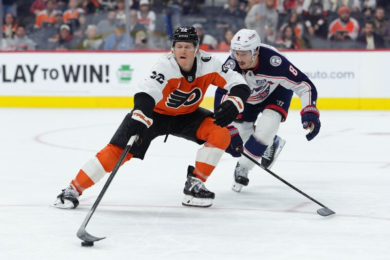Mar 24, 2026; Philadelphia, Pennsylvania, USA; Philadelphia Flyers center Christian Dvorak (22) loses control of the puck against Columbus Blue Jackets defenseman Zach Werenski (8) in the third period at Xfinity Mobile Arena. Mandatory Credit: Kyle Ross-Imagn Images