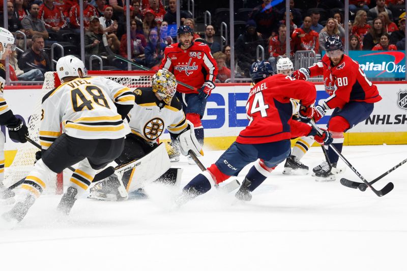 Oct 5, 2024; Washington, District of Columbia, USA; Washington Capitals center Connor McMichael (24) attempts a shot on Boston Bruins goaltender Brandon Bussi (30) in the first period at Capital One Arena. Mandatory Credit: Geoff Burke-Imagn Images