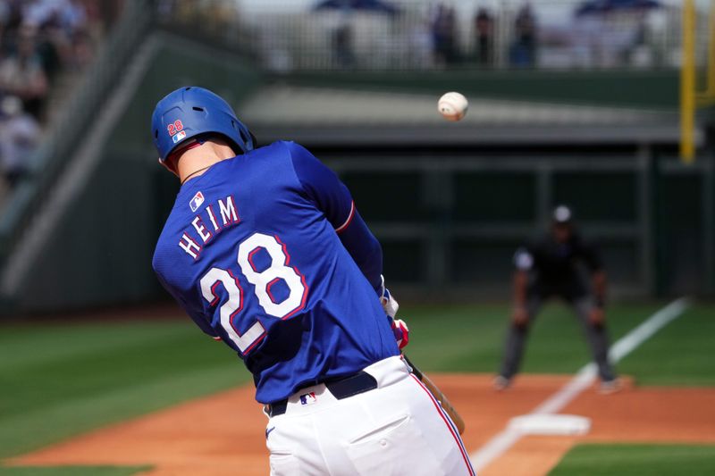 Feb 28, 2024; Surprise, Arizona, USA; Texas Rangers catcher Jonah Heim (28) bats against the Los Angeles Dodgers at Surprise Stadium. Mandatory Credit: Joe Camporeale-USA TODAY Sports