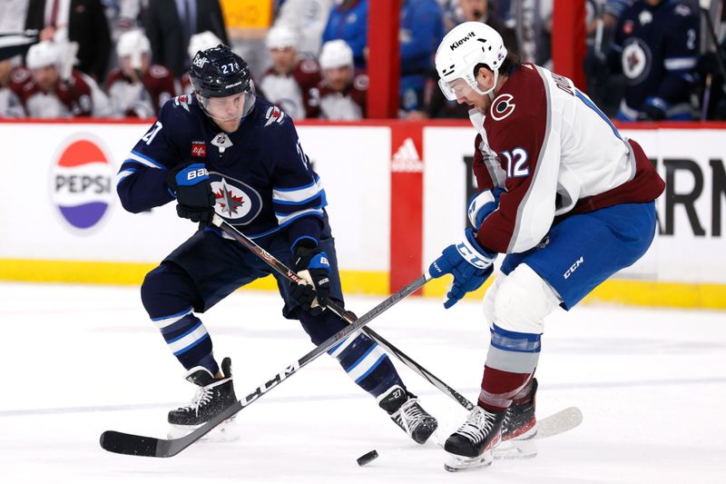 Apr 30, 2024; Winnipeg, Manitoba, CAN; Winnipeg Jets left wing Nikolaj Ehlers (27) and Colorado Avalanche right wing Brandon Duhaime (12) battle for the puck in the second period in game five of the first round of the 2024 Stanley Cup Playoffs at Canada Life Centre. Mandatory Credit: James Carey Lauder-USA TODAY Sports