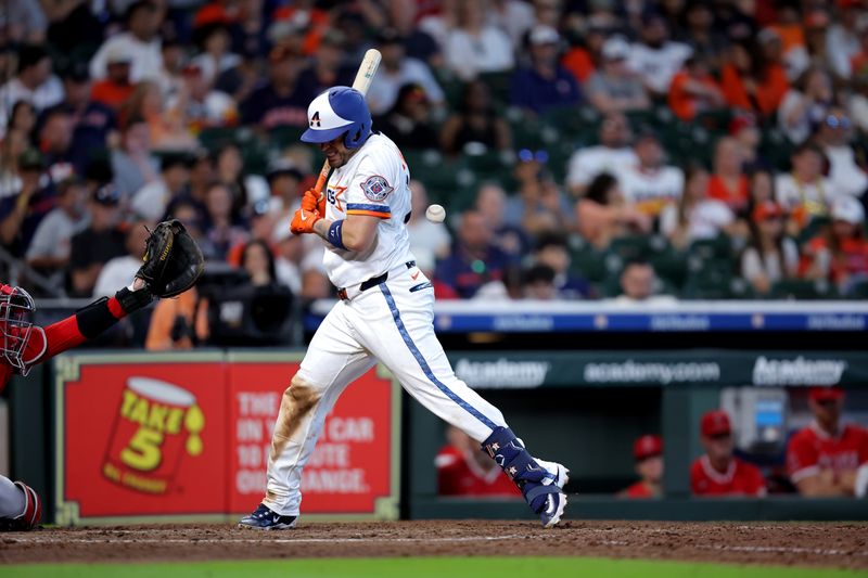 Apr 13, 2025; Houston, Texas, USA; Houston Astros catcher Victor Caratini (17) is hit by a pitch in the back against the Los Angeles Angels during the eighth inning at Daikin Park. Mandatory Credit: Erik Williams-Imagn Images