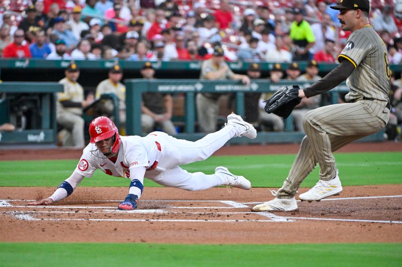 Aug 27, 2024; St. Louis, Missouri, USA;  St. Louis Cardinals shortstop Masyn Winn (0) slides safely past San Diego Padres starting pitcher Dylan Cease (84) and scores on a wild pitch during the first inning at Busch Stadium. Mandatory Credit: Jeff Curry-USA TODAY Sports