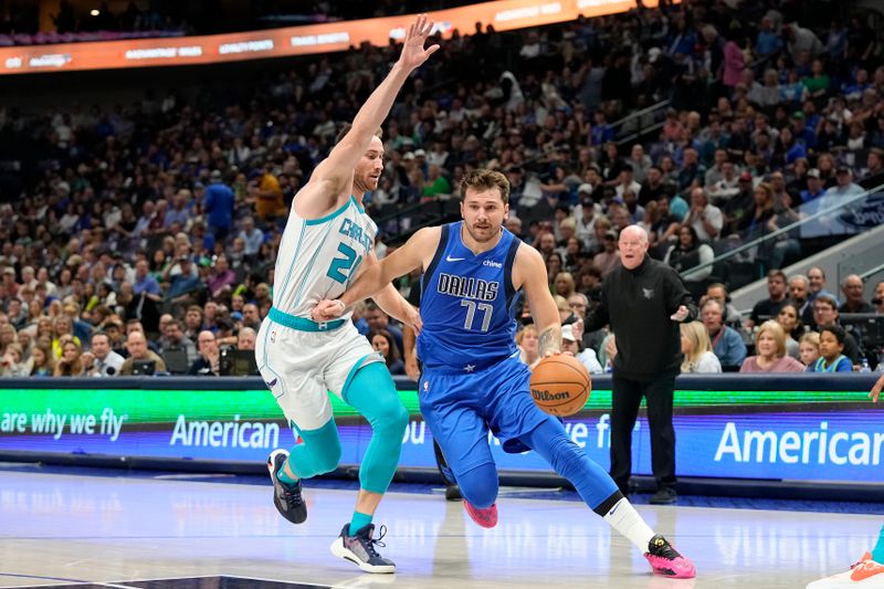 DALLAS, TEXAS - NOVEMBER 05: Luka Doncic #77 of the Dallas Mavericks drives with the ball as Gordon Hayward #20 of the Charlotte Hornets defends during the first half at American Airlines Center on November 05, 2023 in Dallas, Texas. NOTE TO USER: User expressly acknowledges and agrees that, by downloading and or using this photograph, User is consenting to the terms and conditions of the Getty Images License Agreement. (Photo by Sam Hodde/Getty Images)