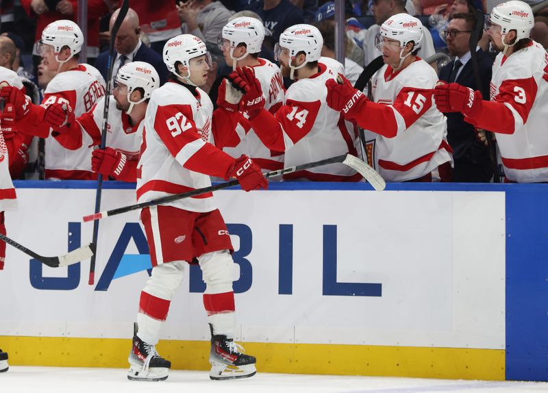 Apr 11, 2025; Tampa, Florida, USA; Detroit Red Wings center Marco Kasper (92) is congratulated after he scored a goal against the Tampa Bay Lightning during the third period at Amalie Arena. Mandatory Credit: Kim Klement Neitzel-Imagn Images