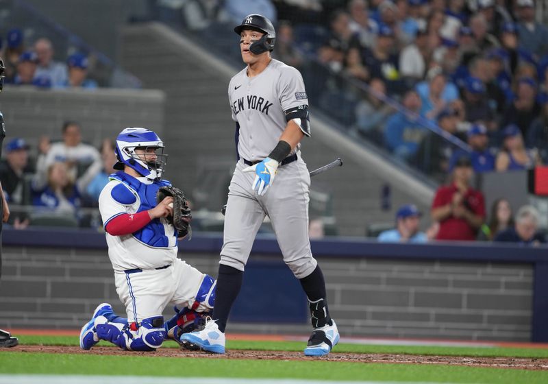 Apr 15, 2024; Toronto, Ontario, CAN; New York Yankees outfielder Aaron Judge wearing number 42 for Jackie Robinson Day walks back to the dugout after striking out against the Toronto Blue Jays during the sixth inning at Rogers Centre. Mandatory Credit: Nick Turchiaro-USA TODAY Sports