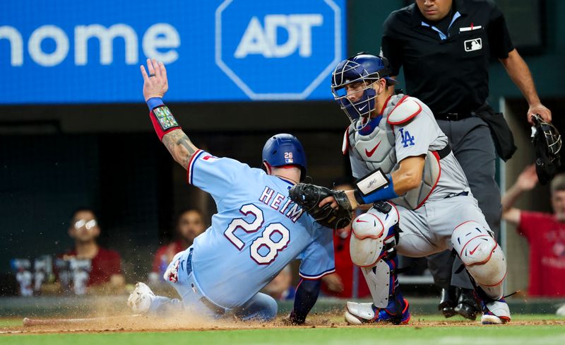 Jul 23, 2023; Arlington, Texas, USA;  Texas Rangers catcher Jonah Heim (28) scores ahead of the tag by Los Angeles Dodgers catcher Austin Barnes (15) during the fourth inning at Globe Life Field. Mandatory Credit: Kevin Jairaj-USA TODAY Sports