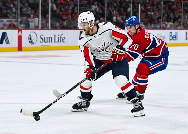 Oct 21, 2023; Montreal, Quebec, CAN; Washington Capitals defenseman Nick Jensen (3) plays the puck against Montreal Canadiens left wing Juraj Slafkovsky (20) during the second period at Bell Centre. Mandatory Credit: David Kirouac-USA TODAY Sports