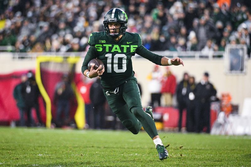 Nov 13, 2021; East Lansing, Michigan, USA; Michigan State Spartans quarterback Payton Thorne (10) runs the ball during the second quarter against the Maryland Terrapins at Spartan Stadium. Mandatory Credit: Tim Fuller-USA TODAY Sports