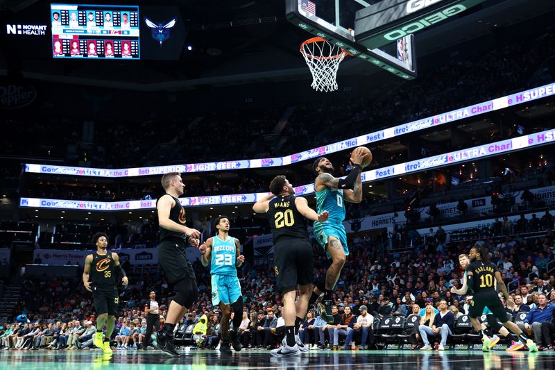 CHARLOTTE, NORTH CAROLINA - MARCH 27: Miles Bridges #0 of the Charlotte Hornets attempts a shot against Georges Niang #20 of the Cleveland Cavaliers during the first half of the game at Spectrum Center on March 27, 2024 in Charlotte, North Carolina. NOTE TO USER: User expressly acknowledges and agrees that, by downloading and or using this photograph, User is consenting to the terms and conditions of the Getty Images License Agreement. (Photo by Jared C. Tilton/Getty Images)