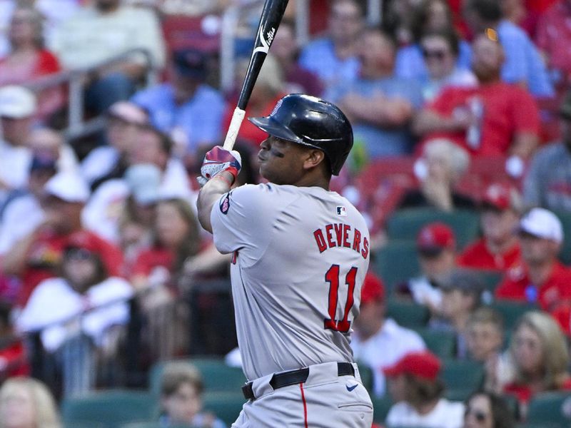 May 18, 2024; St. Louis, Missouri, USA;  Boston Red Sox third baseman Rafael Devers (11) hits a solo home run against the St. Louis Cardinals during the fourth inning at Busch Stadium. Mandatory Credit: Jeff Curry-USA TODAY Sports