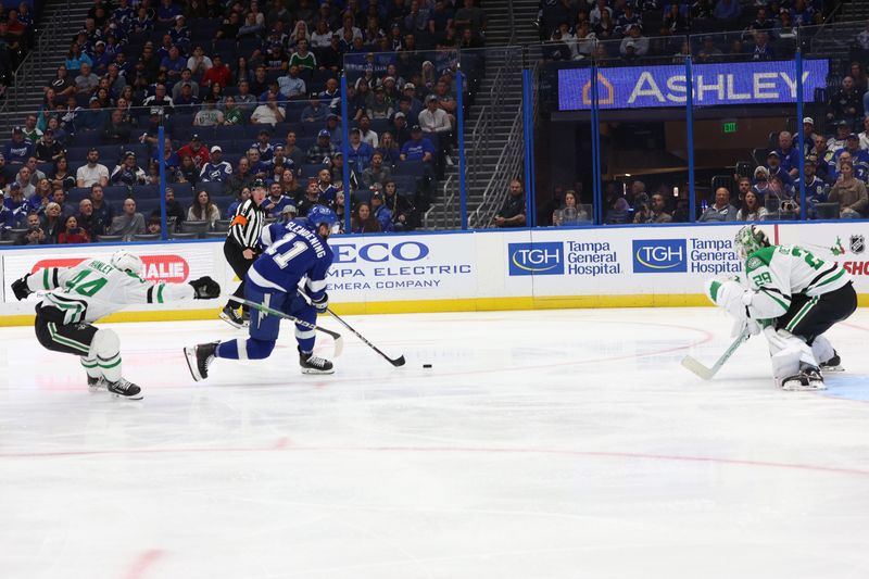 Dec 4, 2023; Tampa, Florida, USA; Tampa Bay Lightning center Luke Glendening (11) scores a goal past Dallas Stars defenseman Joel Hanley (44) on goaltender Jake Oettinger (29)  during the third period at Amalie Arena. Mandatory Credit: Kim Klement Neitzel-USA TODAY Sports