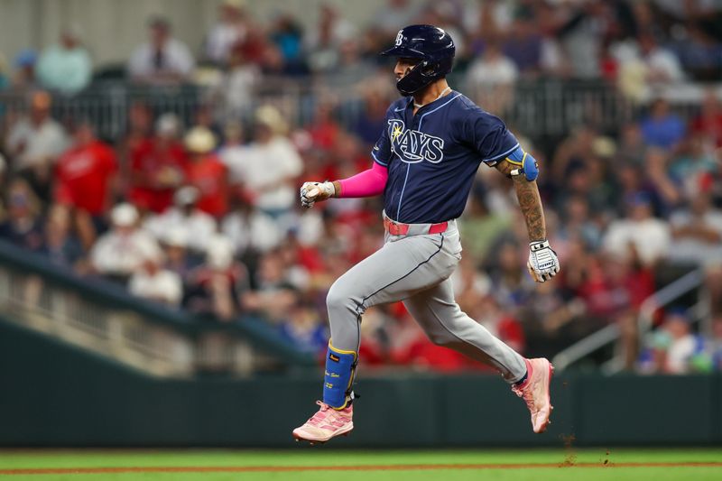 Jun 14, 2024; Atlanta, Georgia, USA; Tampa Bay Rays center fielder Jose Siri (22) hits a double against the Atlanta Braves in the seventh inning at Truist Park. Mandatory Credit: Brett Davis-USA TODAY Sports