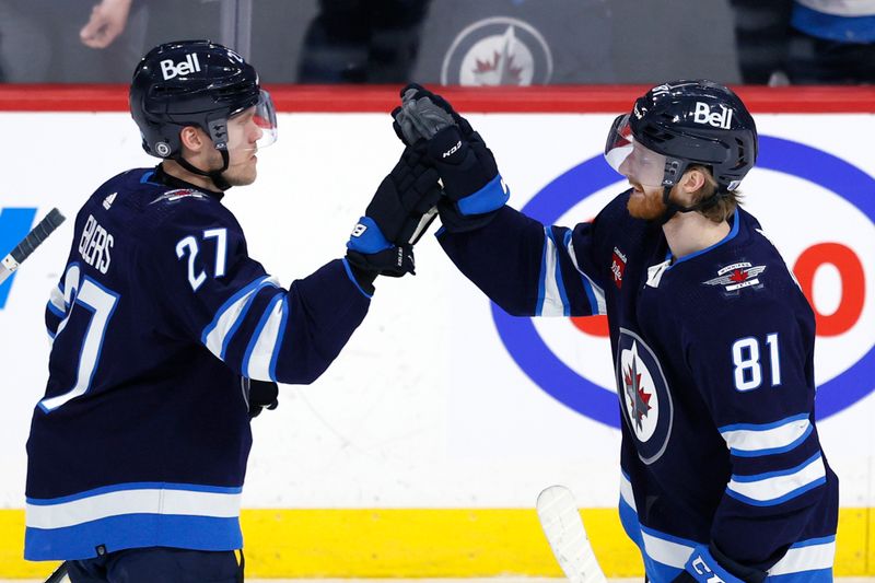 Feb 25, 2024; Winnipeg, Manitoba, CAN; \Winnipeg Jets left wing Kyle Connor (81) celebrates his overtime goal with Winnipeg Jets left wing Nikolaj Ehlers (27) against the Arizona Coyotes at Canada Life Centre. Mandatory Credit: James Carey Lauder-USA TODAY Sports