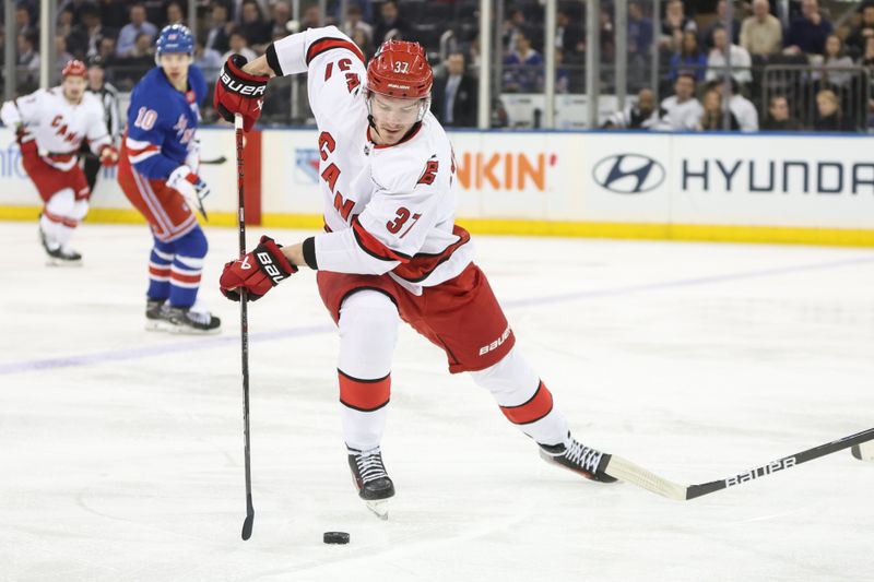 Jan 28, 2025; New York, New York, USA; Carolina Hurricanes right wing Andrei Svechnikov (37) controls the puck in the second period against the New York Rangers at Madison Square Garden. Mandatory Credit: Wendell Cruz-Imagn Images