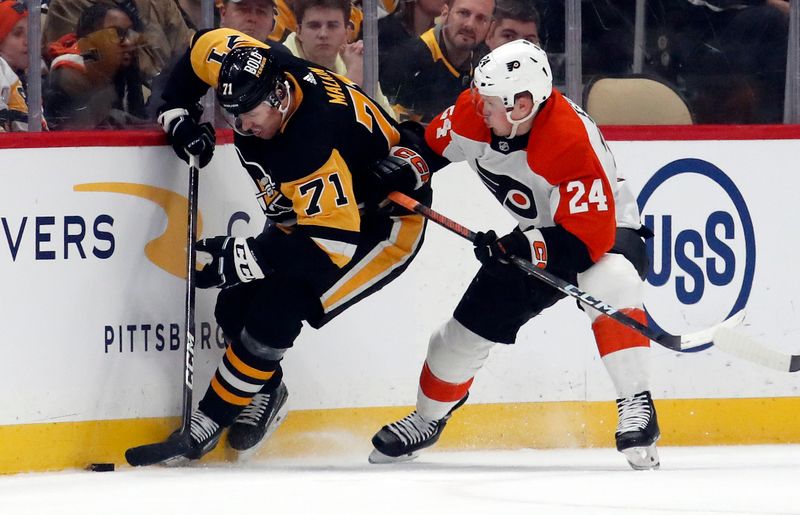 Feb 25, 2024; Pittsburgh, Pennsylvania, USA;  Pittsburgh Penguins center Evgeni Malkin (71) moves the puck against Philadelphia Flyers defenseman Nick Seeler (24) during the first period at PPG Paints Arena. Mandatory Credit: Charles LeClaire-USA TODAY Sports