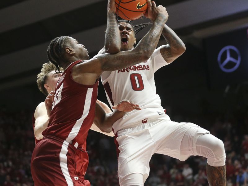 Mar 9, 2024; Tuscaloosa, Alabama, USA;  Arkansas guard Khalif Battle (0) goes for a shot in the lane against Alabama forward Nick Pringle (23) at Coleman Coliseum. Alabama came from behind to win on overtime 92-88. Mandatory Credit: Gary Cosby Jr.-USA TODAY Sports