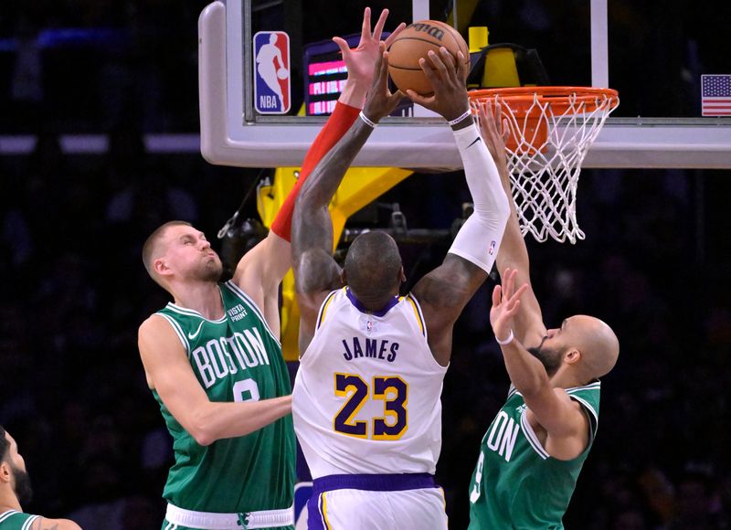 LOS ANGELES, CALIFORNIA - DECEMBER 25: Kristaps Porzingis #8 and Derrick White #9 of the Boston Celtics defend a shot by LeBron James #23 of the Los Angeles Lakers in the second half at Crypto.com Arena on December 25, 2023 in Los Angeles, California. NOTE TO USER: User expressly acknowledges and agrees that, by downloading and or using this photograph, User is consenting to the terms and conditions of the Getty Images License Agreement.(Photo by Jayne Kamin-Oncea/Getty Images)