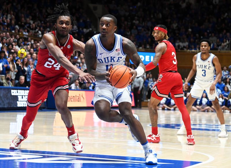 Feb 20, 2023; Durham, North Carolina, USA; Duke Blue Devils forward Dariq Whitehead (0) moves to the basket as Louisville Cardinals forward Jae'Lyn Withers (24) defends during the second half at Cameron Indoor Stadium. The Blue Devils won 79-62. Mandatory Credit: Rob Kinnan-USA TODAY Sports