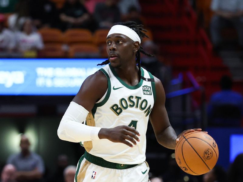 MIAMI, FLORIDA - FEBRUARY 11: Jrue Holiday #4 of the Boston Celtics dribbles the ball against the Miami Heat during the first quarter of the game at Kaseya Center on February 11, 2024 in Miami, Florida. NOTE TO USER: User expressly acknowledges and agrees that, by downloading and or using this photograph, User is consenting to the terms and conditions of the Getty Images License Agreement. (Photo by Megan Briggs/Getty Images)