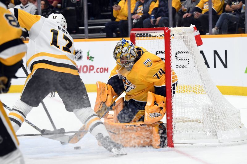 Nov 28, 2023; Nashville, Tennessee, USA; Nashville Predators goaltender Juuse Saros (74) makes a save on a shot by Pittsburgh Penguins right wing Bryan Rust (17) during the second period at Bridgestone Arena. Mandatory Credit: Christopher Hanewinckel-USA TODAY Sports