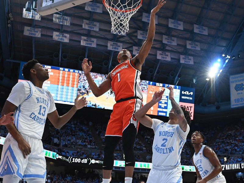 Jan 13, 2024; Chapel Hill, North Carolina, USA; Syracuse Orange forward Benny Williams (13) shoots as North Carolina Tar Heels forward Jalen Washington (13) and guard Elliot Cadeau (2) defend in the first half at Dean E. Smith Center. Mandatory Credit: Bob Donnan-USA TODAY Sports