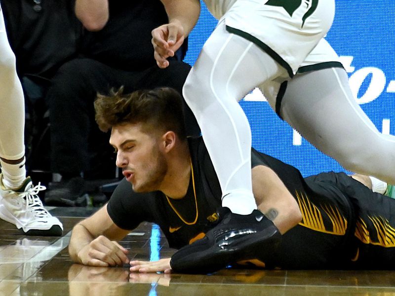 Feb 20, 2024; East Lansing, Michigan, USA;  Michigan State Spartans guard A.J. Hoggard (11) takes the ball from Iowa Hawkeyes forward Owen Freeman (32) during the first half at Jack Breslin Student Events Center. Mandatory Credit: Dale Young-USA TODAY Sports
