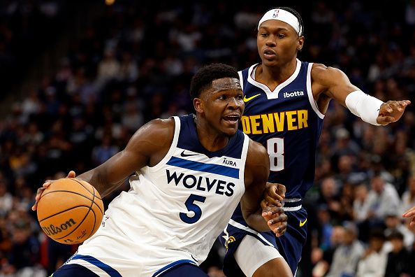 MINNEAPOLIS, MINNESOTA - NOVEMBER 01: Anthony Edwards #5 of the Minnesota Timberwolves drives to the basket while Peyton Watson #8 of the Denver Nuggets defends in the first quarter at Target Center on November 01, 2023 in Minneapolis, Minnesota. The Timberwolves defeated the Nuggets 110-89. NOTE TO USER: User expressly acknowledges and agrees that, by downloading and or using this photograph, User is consenting to the terms and conditions of the Getty Images License Agreement. (Photo by David Berding/Getty Images)