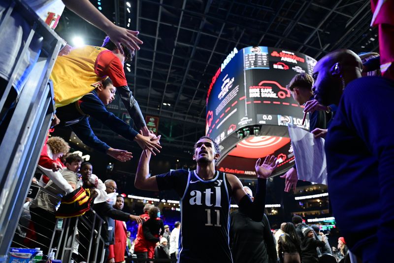 ATLANTA, GA - JANUARY 15: Trae Young #11 of the Atlanta Hawks high fives fans after the game against the San Antonio Spurson January 15, 2024 at State Farm Arena in Atlanta, Georgia.  NOTE TO USER: User expressly acknowledges and agrees that, by downloading and/or using this Photograph, user is consenting to the terms and conditions of the Getty Images License Agreement. Mandatory Copyright Notice: Copyright 2024 NBAE (Photo by Adam Hagy/NBAE via Getty Images)