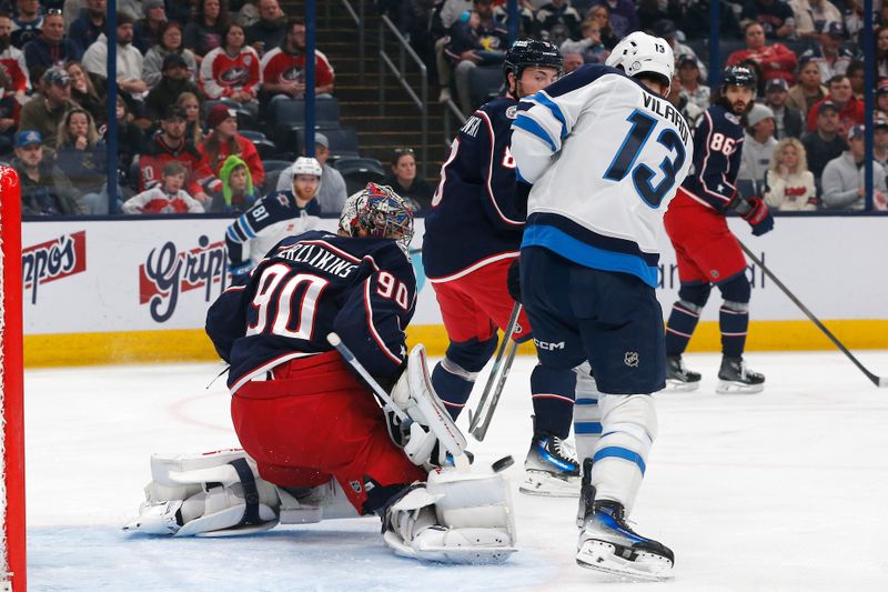 Nov 1, 2024; Columbus, Ohio, USA; Columbus Blue Jackets goalie Elvis Merzlikins (90) makes a pad save as Winnipeg Jets center Gabriel Vilardi (13) looks for a rebound during the first period at Nationwide Arena. Mandatory Credit: Russell LaBounty-Imagn Images